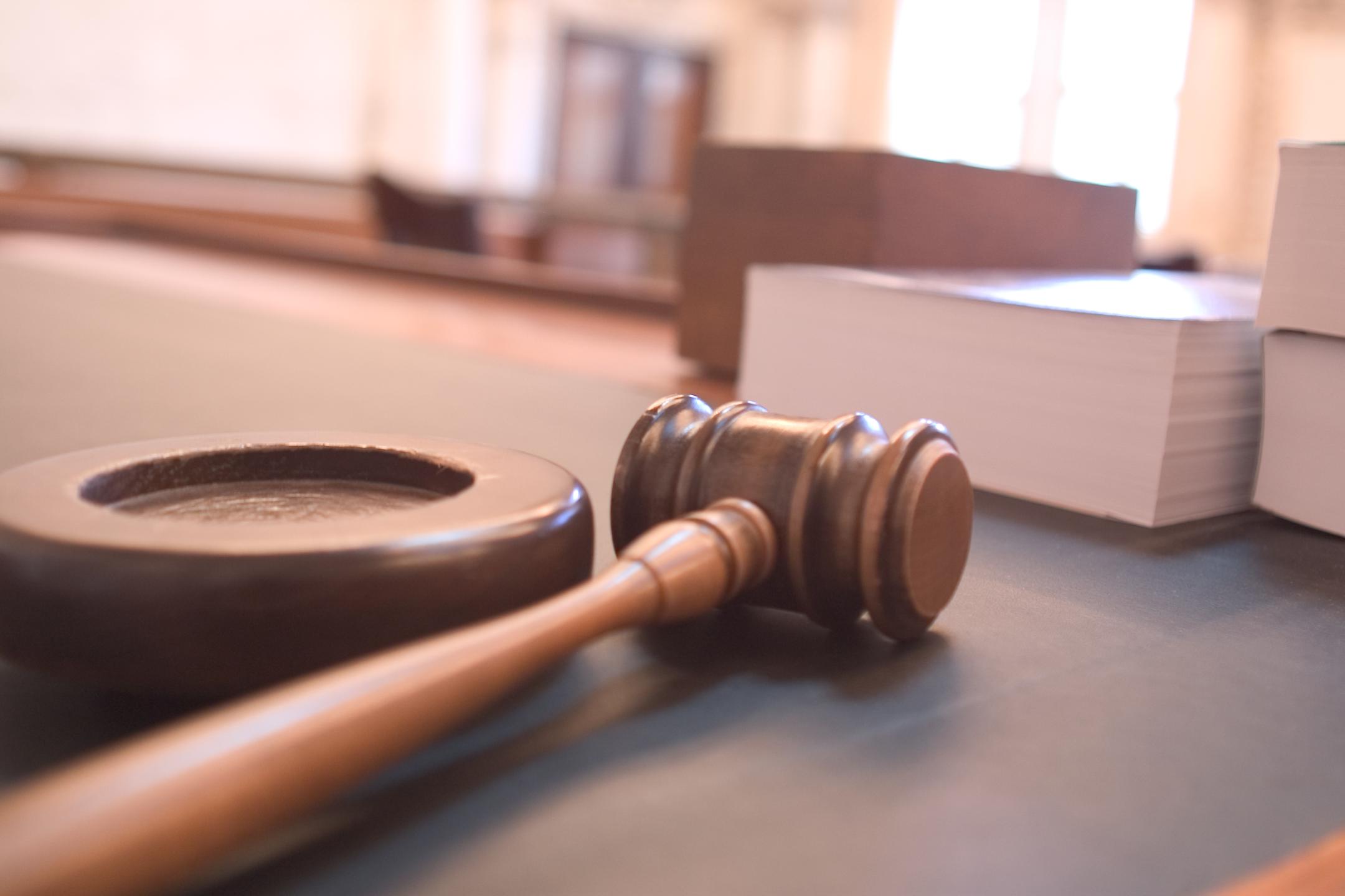 Judge's gavel and law books in a courtroom