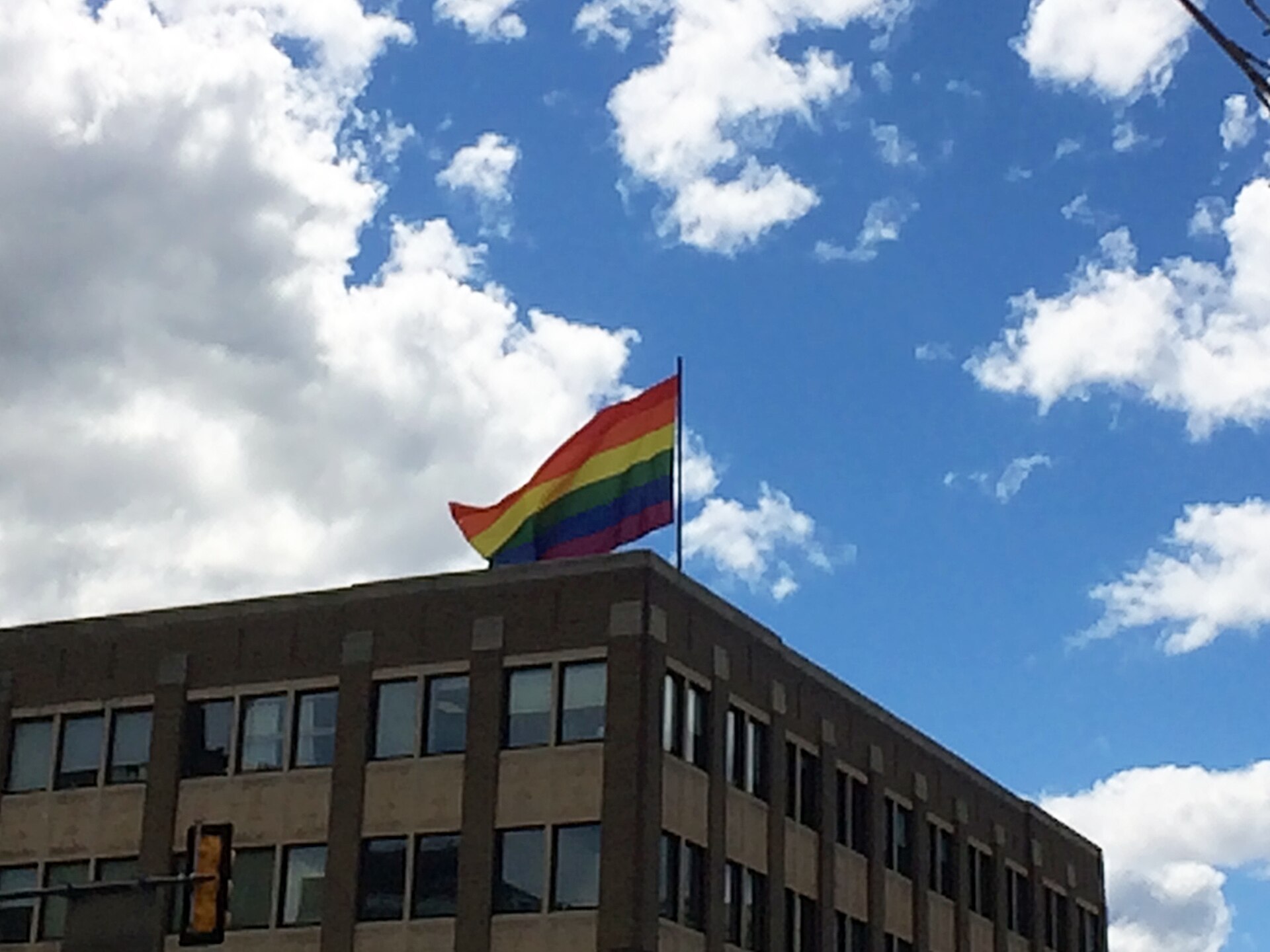 Rainbow flag flying above a building