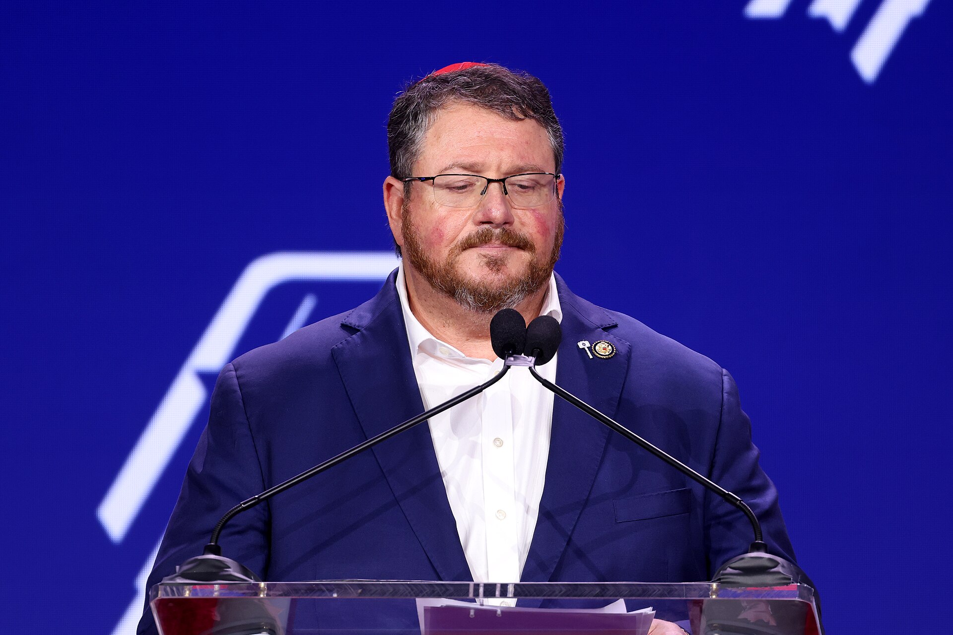 Representative Randy Fine speaking at a podium